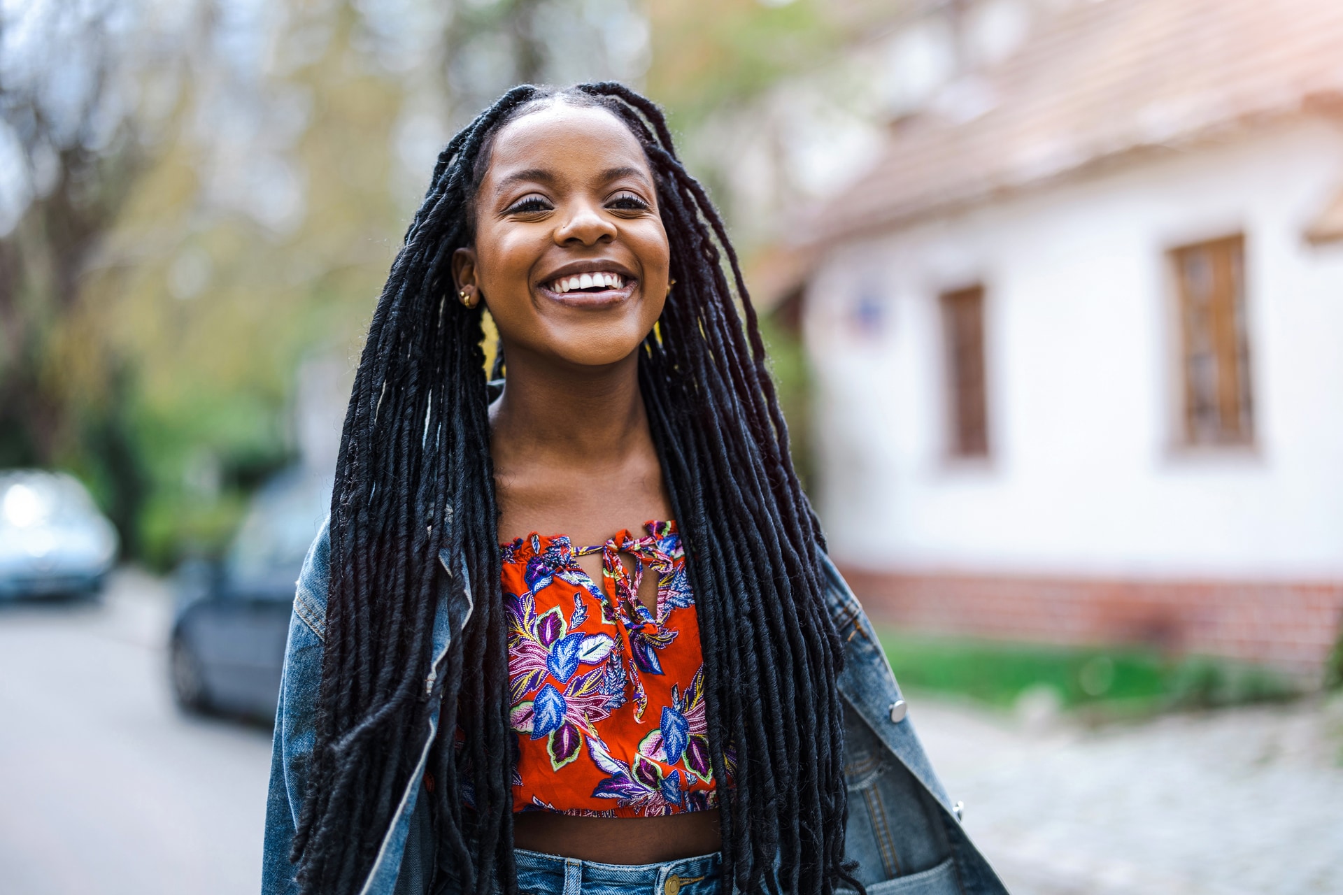 Young woman smiling on a neighborhood sidewalk